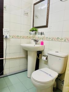 a bathroom with a toilet and a sink at BluO Studio Defence Colony Mkt - Kitchen, Balcony in New Delhi +15 photos