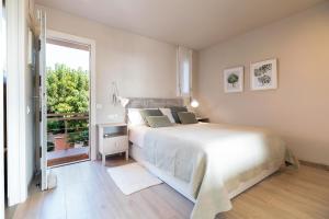 a bedroom with a large bed and a large window at Ocean view apartment renovated in Gavà +23 photos