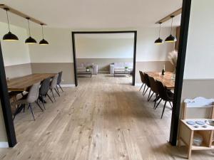 a dining room with tables and chairs and a mirror at Waldhaus Kustelberg in Medebach