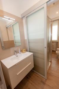a bathroom with a sink and a mirror at Rossini15 - garage privato in Alba