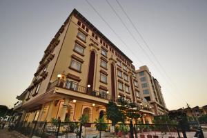 a yellow building with a balcony on the side of it at Umaid Residency - A Regal Heritage Home in Jaipur