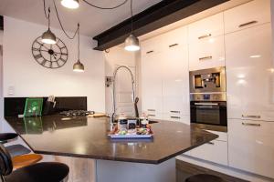 a kitchen with a island with a counter top at La chouette au bouleau in Hargnies