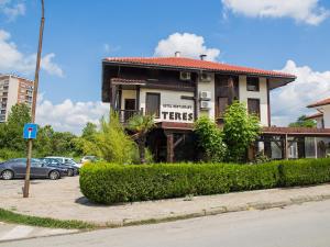 a building with a sign on the side of it at Hotel Teres in Kazanlŭk