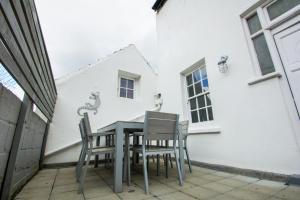 a table and chairs sitting on a patio at Marine Cottage - Parking - by Brighton Holiday Lets in Brighton & Hove