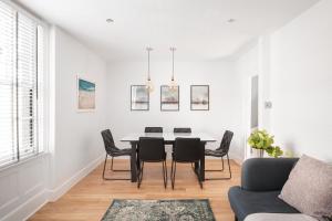 a white dining room with a table and chairs at Worthing town house in Worthing