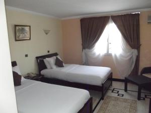 Postel nebo postele na pokoji v ubytování Hotel Al Kabir