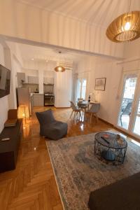 a living room with a couch and a table at Athenian Port Luxury Apartment 1/Piraeus Riviera in Piraeus