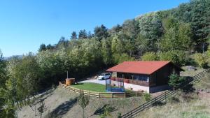 a small house with a red roof on a hill at Panorama House in Praid