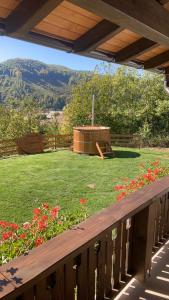 a wooden deck with a garden with a hot tub at Panorama House in Praid