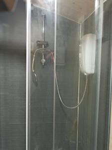 a shower in a bathroom with a glass door at Cabin Dan in Great Malvern