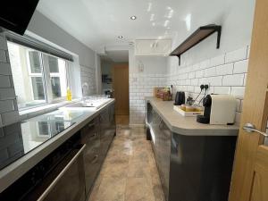a kitchen with a sink and a counter top at Glenderamackin Cottage in Threlkeld +13 photos