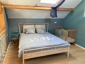 a bedroom with a bed with a wooden frame at La Sérénade in La-Roche-en-Ardenne