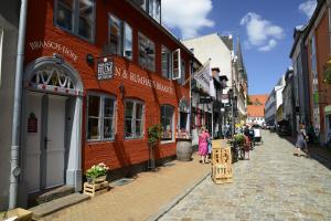 a cobblestone street in a city with people walking down it at fewo1846 - Angelburg - komfortable Wohnung im Stadtzentrum in Flensburg