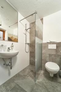 a bathroom with a shower and a toilet and a sink at Gästehaus Judith in Sölden