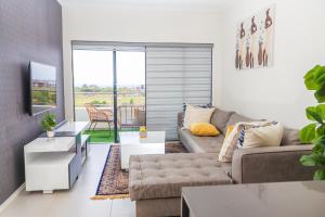 a living room with a couch and a table at Fumo House Lifestyle Apartments in Midrand