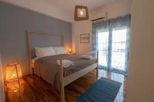 a bedroom with a bed and a large window at Athenian Port Luxury Apartment 2/Piraeus Riviera in Piraeus