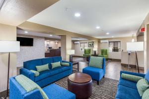 a lobby with blue couches and chairs and a table at Comfort Inn in Charleston