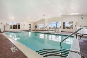 a large swimming pool with blue water in a building at Quality Inn Lincoln Cornhusker in Lincoln
