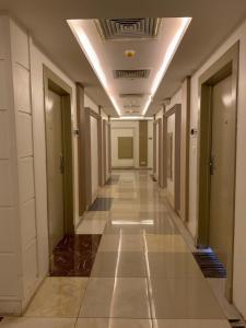 a hallway with a door leading into a room at Almakan Hotel 113 in Riyadh