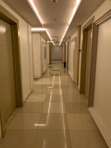 a hallway with a door open and a hallway with a door open at Almakan Hotel 113 in Riyadh