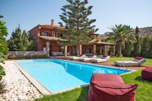a villa with a swimming pool in front of a house at Villa Terra Mare in Vari