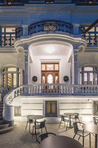 a room with tables and chairs in a building at Casa Popeea Boutique Hotel in Brăila