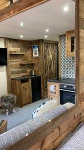 a kitchen with wooden walls and a bed in a room at Studio Mezzanine Megeve centre in Megève