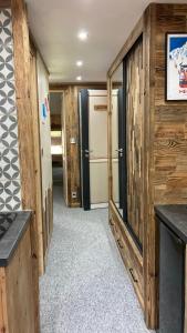 a room with wooden walls and a hallway with a refrigerator at Studio Mezzanine Megeve centre in Megève