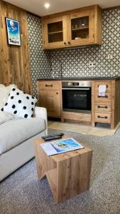 a living room with a couch and a coffee table at Studio Mezzanine Megeve centre in Megève