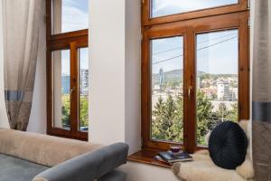 a living room with a couch and a window at Villa Adelaida in Sarajevo