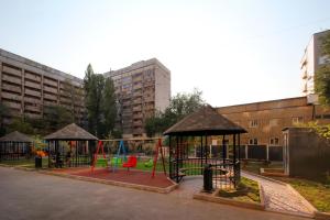 a playground with swings and play equipment in a city at Cozy studio in the best area! 3 in Almaty