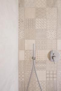 a shower in a bathroom with a tile wall at Alexandra B&B & Brunch -Beach Front Parking Included in Misano Adriatico +212 photos
