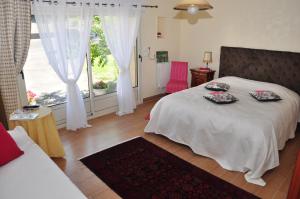 a bedroom with a bed with two plates on it at La Grande Malardiere in Saint-Georges-Buttavent