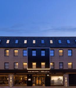 a building with a solar roof on top of it at River Ness Hotel, a member of Radisson Individuals in Inverness