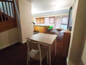a room with a table and chairs and a kitchen at Bankwell Guest House in Manchester +15 photos