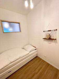 a small room with a bed with a window at Angel Apartment Černý důl in Černý Dŭl