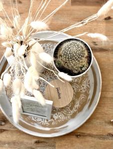 a white plate with a cup of incense on a table at L’Escale - Le Boho + garage + NETFLIX in Saint-Étienne