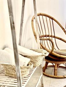 a rocking chair and baskets on a ladder at L’Escale - Le Boho + garage + NETFLIX in Saint-Étienne