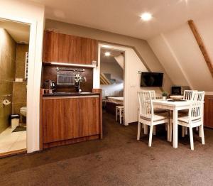 a kitchen and dining room with a table and chairs at Planinski vrhovi Jelač in Kopaonik