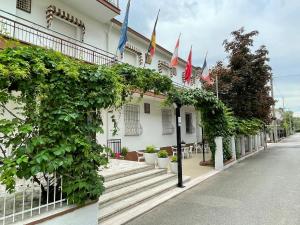 a building with flags on the side of it at Hotel Villa Sorci in Rimini