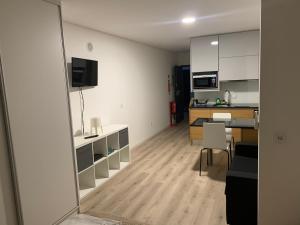 a living room with a kitchen and a dining room at Liberty Guest House in Ponte de Sor