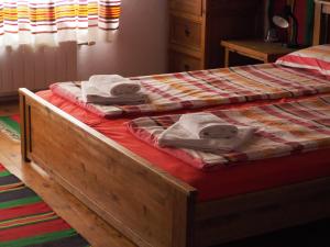 a bed with towels sitting on top of it at Baba Stana Houses in Apriltsi
