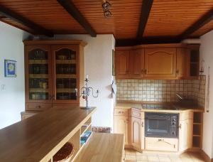 uma cozinha com armários de madeira e uma bancada em Montanregion Erzgebirge-Ihr Urlaub ist unsere Herzenssache em Langenberg