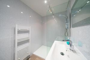 a white bathroom with a sink and a shower at Rosemount Residence in Aberdeen