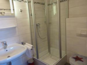 a bathroom with a shower and a sink at Apartmenthaus Sonnenschein - Chiemgau Karte in Inzell +33 photos