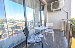 a balcony with a table and chairs and a window at Royal Accommodation in Bucharest