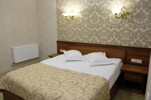 a bedroom with a bed with two pillows on it at Лісовий готель Гайки in Zhytomyr