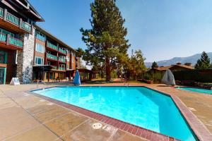 a swimming pool in front of a building at Juniper Springs 444 in Mammoth Lakes