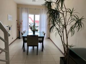 a dining room with a table and a potted plant at Cobertura Duplex Algodoal in Cabo Frio