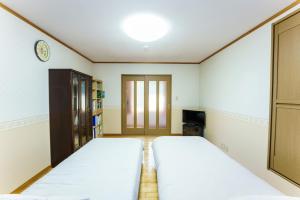 A bed or beds in a room at Bunzaemon